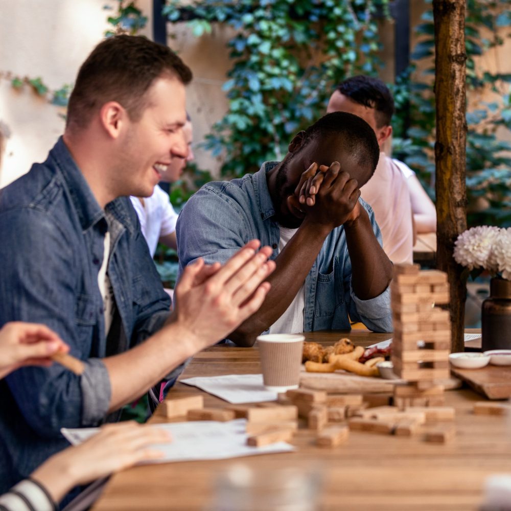Breaking jenga tower and laughing with best friends at the cosy open air restaurant